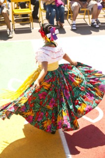 Hispanic girl in costume dancing