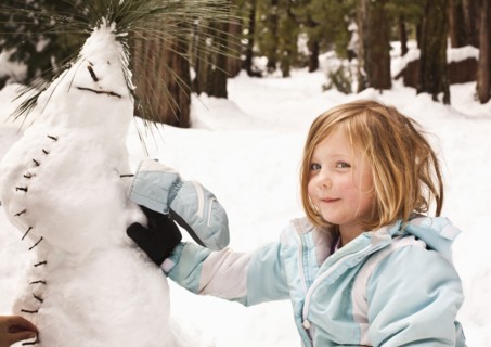 Caucasian girl making strange snowman