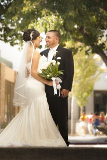 Smiling Hispanic bride and groom