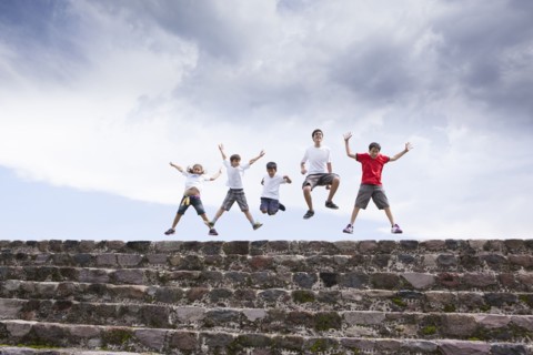 Children jumping on top of steps