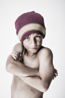 Angry mixed race boy with arms crossed