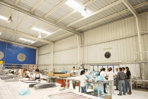 Workers talking in manufacturing plant