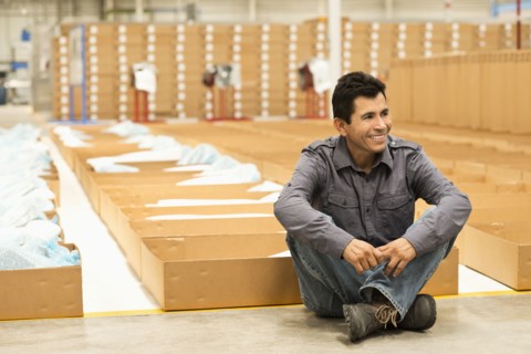 Worker smiling in manufacturing plant