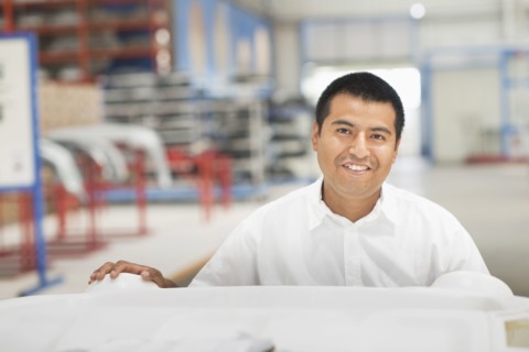 Worker smiling in manufacturing plant