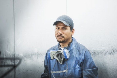 Worker standing in manufacturing plant