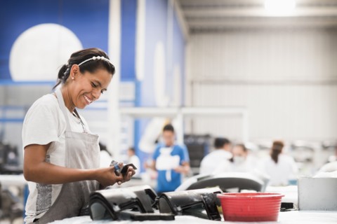 Worker smiling in manufacturing plant