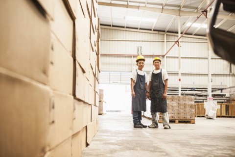 Workers standing in manufacturing plant