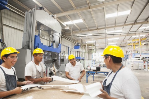 Workers talking in manufacturing plant