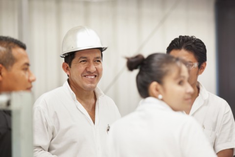 Worker smiling in manufacturing plant