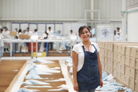 Worker smiling in manufacturing plant