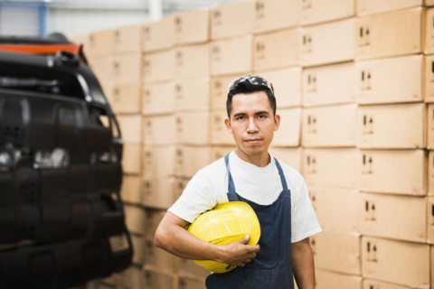 Worker standing in manufacturing plant