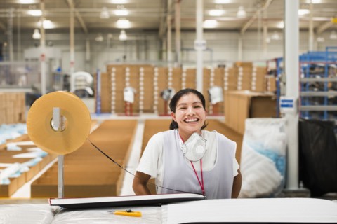 Worker smiling in manufacturing plant