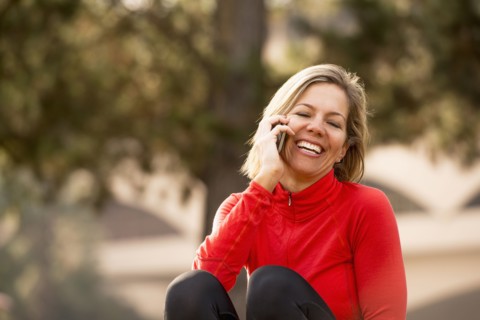 Caucasian woman talking on cell phone outdoors
