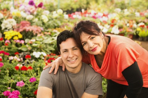 Hispanic couple smiling in field
