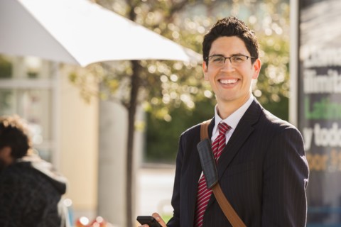 Hispanic businessman smiling outdoors