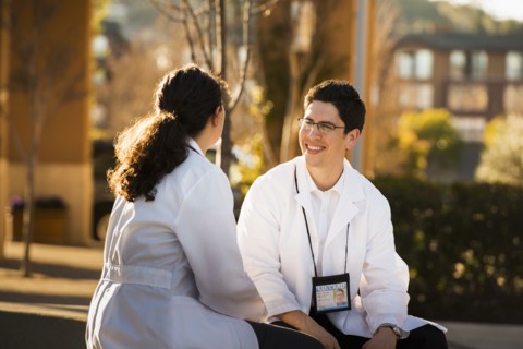 Hispanic doctors talking outdoors