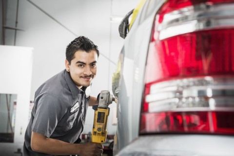 Hispanic mechanic working in auto shop