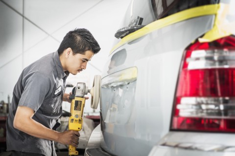 Hispanic mechanic working in auto shop