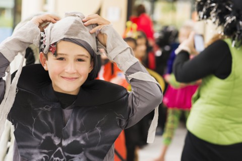 Portrait of smiling Caucasian boy in mummy costume