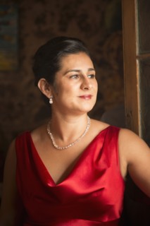 Hispanic woman wearing evening gown