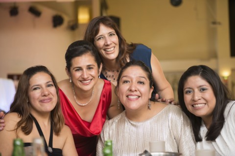 Hispanic family smiling at wedding reception
