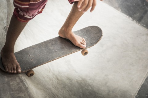 Mixed race boy riding skateboard in skate park