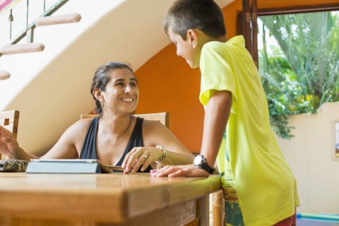 Mother and son talking at table