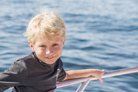 Caucasian boy smiling on boat