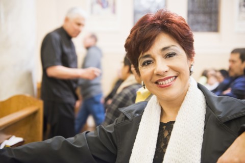 Hispanic woman smiling in church