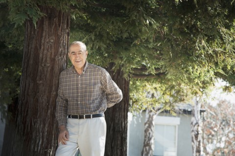 Hispanic man smiling outdoors