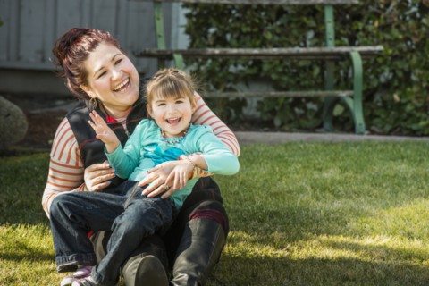 Mother and daughter smiling outdoors