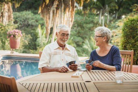 Caucasian couple playing cards outdoors