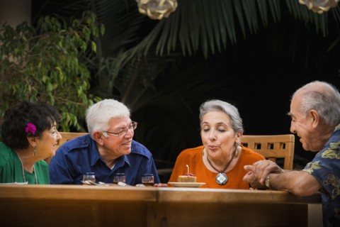 Hispanic couples celebrating birthday outdoors