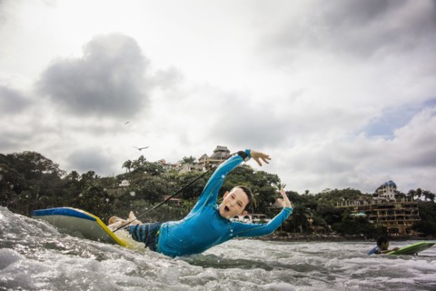 Boys surfing together in waves
