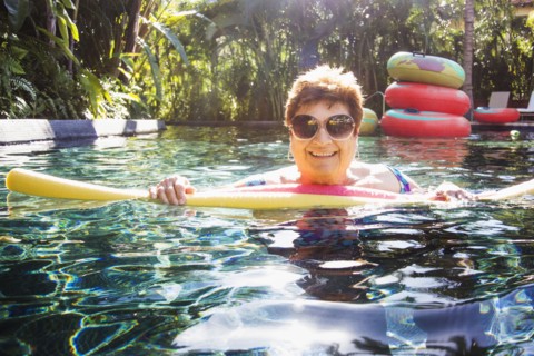 Older woman with sunglasses in swimming pool
