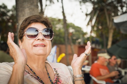 Older woman clapping outdoors