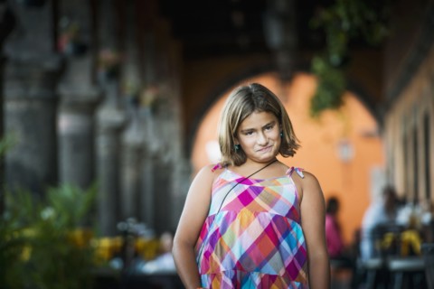 Hispanic girl making a face outdoors