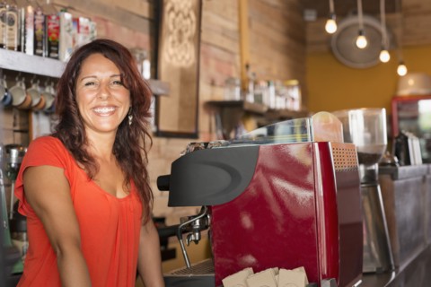 Smiling Hispanic woman working in coffee shop