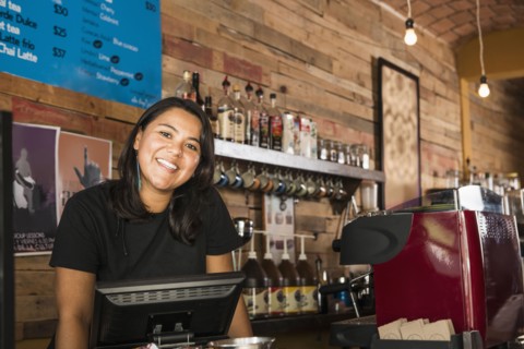 Hispanic woman working in coffee shop