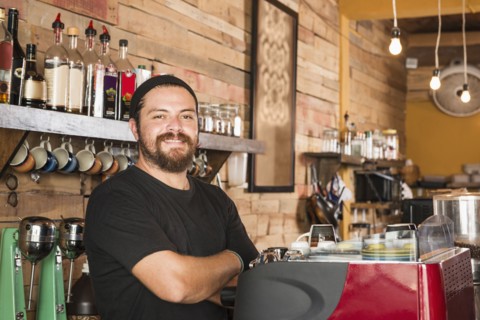 Hispanic man working in coffee shop