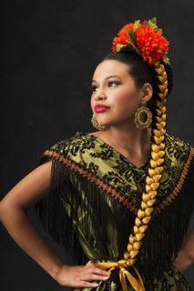 Hispanic teenage girl dancing in Puebla Folkloric dress