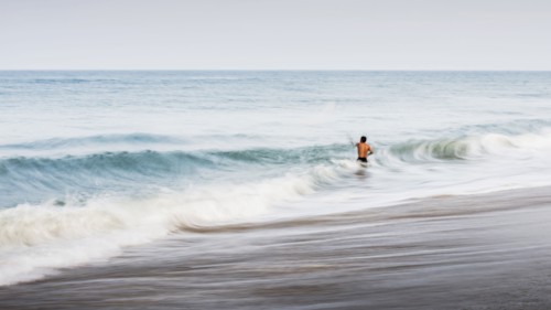 Man swimming in waves