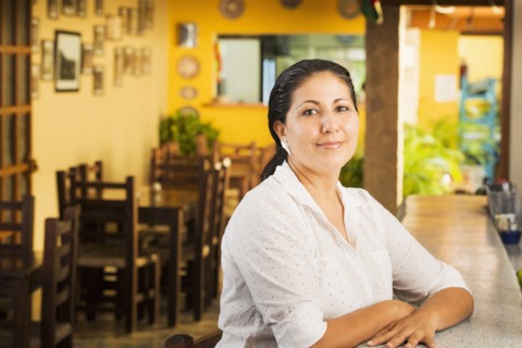 Smiling woman at counter in restaurant
