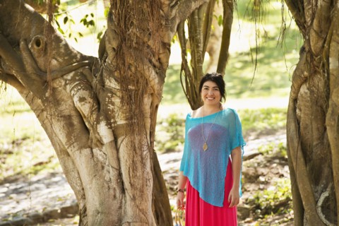 Hispanic woman smiling in jungle