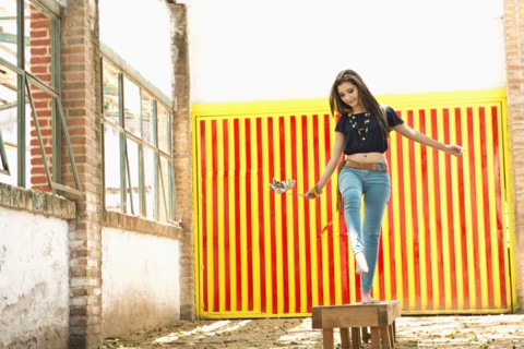 Hispanic woman balancing on platform