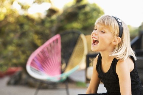 Caucasian girl shouting in backyard