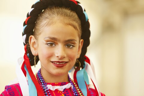 Mixed race girl wearing traditional makeup and dress