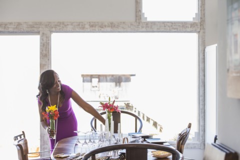 Woman setting dining table