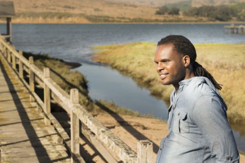 African American man standing on wooden deck