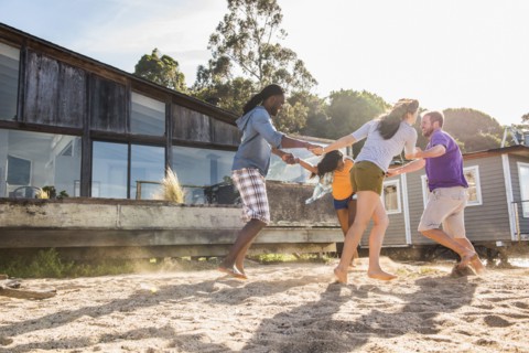 Friends playing in sand